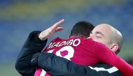 Jubilant Qatari player Assim Madibo embraces coach Felix Sanchez after their win against South Korea in the AFC U-23 Asian Cup third place play-off match in Kunshan, China  