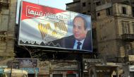 Egyptians walk underneath an election campaign poster erected by supporters of Egyptian President Abdel Fattah al-Sisi, in Cairo, Egypt, 28 January 2018. EPA/Khaled Elfiqi


