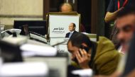 Members of Egyptian President Abdel Fattah al-Sisi presidential campaign staff sift through boxes containing signatures in his support, needed to register for the elections, at the National Election Authority, in Cairo on January 24, 2018.   AFP / MOHAMED
