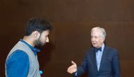 Matthew Winkler engaging in a discussion with a NU-Q student, Muhammad Chaudary, after his session.