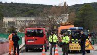French gendarmes stand guard near the site of an accident near Carces lake, about 50 kilometres (30 miles) northwest of the resort of Saint-Tropez, on February 2, 2018, as the road is blocked after two army helicopters crashed into each other. AFP / Anne-