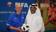 FIFA Technical Director, Steven Martens (left) Gifts Director of Football Development Department at QFA, Fahad Al Zaraa the Official FIFA World Cup Match Ball during the FIFA Technical Experts’ Workshop 2018 at the QFA headquarters yesterday.