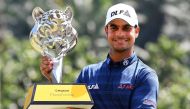 Shubhankar Sharma of India poses with the trophy after winning the 2018 Maybank Malaysia Golf Championship at the Saujana Golf and Country Club outside Kuala Lumpur on February 4, 2018. / AFP / MANAN VATSYAYANA
