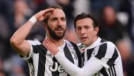 Juventus' Argentinian forward Gonzalo Higuain (L) celebrates with his teammate Juventus' Italian midfielder Federico Bernardeschi (R) after scoring a goal during the Italian Serie A football match between Juventus and Sassuolo on February 4, 2018 at the '