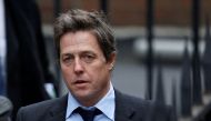 FILE PHOTO: British actor Hugh Grant arrives at the Leveson Inquiry at the High Court in central London, Britain November 21, 2011. REUTERS/Andrew Winning/File Photo