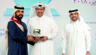 Rashid bin Ali Al Mansoori (left), CEO of QSE giving away the award to QNB official at the 3rd Annual IR Excellence Program,  as Abdul Aziz Al Emadi, Director, Listing Department of QSE, looks on. 
Pic : Abdul Basit