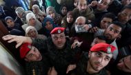 Members of Palestinian Hamas security forces stand guard as people ask for travel permits to cross into Egypt through the Rafah border crossing after it was opened by Egyptian authorities for humanitarian cases, in the southern Gaza Strip February 7, 2018