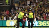 Australia's Aaron Finch (L) celebrates the Aussies 3rd series win with D'Arcy Short (R) during the Twenty20 International Tri-Series cricket match between England and Australia at the MCG in Melbourne on February 10, 2018. AFP / CON CHRONIS 
