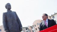 Milorad Dodik watches as a statue of Gavrilo Princip, the man who shot dead the heir to the Habsburg throne a century ago, thumbing their nose at the country’s official commemoration of the act that triggered World War One, is uncovered during an opening 