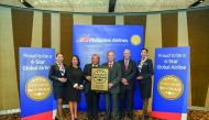 Philippines Airlines officials with staff members with the four-star certificate.