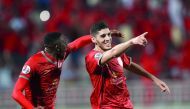 Al Duhail’s Karim Boudiaf (right) celebrates with a team-mate after scoring against Iranian Zobahan during their AFC Champions League match played at the Abdullah bin Khalifa Stadium in Doha yesterday.