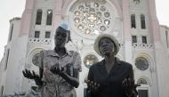 In this file photo taken on January 24, 2010 Haitians pray during mass outside the ruined cathedral in Port-au-Prince following a devastating earthquake.  AFP / Jean-Philippe Ksiazek