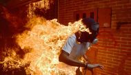 (FILES) In this file photo taken on May 03, 2017 A demonstrator catches fire during clashes with riot police within a protest against Venezuelan President Nicolas Maduro. AFP / RONALDO SCHEMIDT