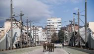 Soldiers of the NATO led-peacekeeping mission in Kosovo cross the main bridge in the divided town of Mitrovica, on February 1, 2018.  AFP / Armend NIMANI