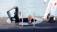 Israeli Prime Minister Benjamin Netanyahu climbs out after a visit inside the Rahav, the fifth submarine in the fleet after it arrived in the Haifa port,  January 12, 2016. (Reuters / Baz Ratner) 