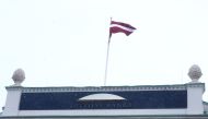 A national flag flutters over the Latvian central bank's headquarters in Riga, Latvia February 18, 2018. REUTERS/Ints Kalnins