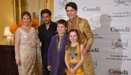 Canadian Prime Minister Justin Trudeau (R), his wife Sophie Grégoire Trudeau (L), daughter Ella-Grace (2R) and son Xavier James (3R) pose for a photograph with Bollywood actor Shahrukh Khan in Mumbai on February 20, 2018. trudeau and his family are visiti