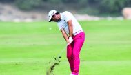 Adrian Otaegui of Spain plays a shot during the second round of the Qatar Masters golf tournament at the Doha Golf Club in Doha, yesterday.