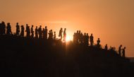 (FILE PHOTO) In this file photo taken on November 26, 2017 Rohingya Muslim refugees walk down a hillside in the Kutupalong refugee camp in Cox's Bazar.  AFP / Ed JONES
