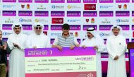 Eddie Pepperell (centre) of England receiving the winner’s cheque from officials during the awards ceremony at the Commercial Bank Qatar Masters golf tournament at the Doha Golf Club in Doha, yesterday.