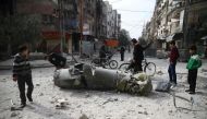 People inspect missile remains in the besieged town of Douma, in eastern Ghouta, in Damascus, Syria, February 23, 2018. REUTERS/Bassam Khabieh