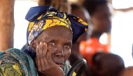 File photo of a Congolese elderly woman, who migrated from Democratic Republic of Congo by fleeing on a boat across Lake Albert, waits to be registered by United Nations High Commission for Refugees (UNHCR) in Ntoroko, Uganda February 17, 2018. REUTERS/Ja