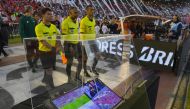 (FILES) In this file photo taken on October 25, 2017 Brazilian referee Wilton Pereira Sampaio (C) and his assistants pass by a screen of the Video Assistant Referee (VAR) before the start of the Copa Libertadores 2017 semifinal first leg football match be