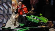 Best Costume Design winner Mark Bridges rides a jet ski onto the stage with actress Helen Mirren on the back after he won it for the shortest Oscar acceptance speech of 2018. REUTERS/Lucas Jackson
