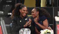 Serena Williams (L) of the US speaks with her sister Venus Williams (R) before their matches in the Tie Break Tens New York tournament at Madison Square Garden March 5, 2018, featuring eight of the tour’s top female players competing for the $250,000 winn