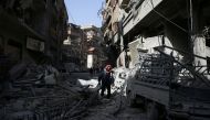 A man walks on the rubble of damaged buildings at the besieged town of Douma, Eastern Ghouta, Damascus, Syria March 5, 2018. REUTERS/Bassam Khabieh