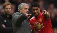 Liverpool's German manager Jurgen Klopp (L) watches as Manchester United's Portuguese manager Jose Mourinho (C) talks with Manchester United's English striker Marcus Rashford during the English Premier League football match between Manchester United and L