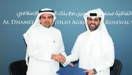 Abdulaziz bin Nasser Al Khalifa (right), CEO of QDB; and Dr Abdulbasit Ahmad Al Shaibei, QIIB Chief Executive Officer, shake hands after signing the deal at the QDB head office, yesterday.