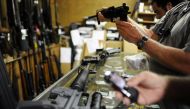 Customers look over the last two AR-15 style rifles for sale inside the Bullet Hole gun shop in Sarasota, Florida. (Reuters) 