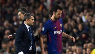 Barcelona's Spanish midfielder Sergio Busquets (R) walks with Barcelona's Spanish coach Ernesto Valverde as he is substituted during the UEFA Champions League round of sixteen second leg football match between FC Barcelona and Chelsea FC at the Camp Nou s