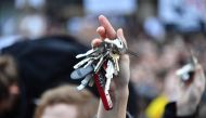 A protester holds up keys near the Slovak National Uprising (SNP) square during a rally under the slogan 