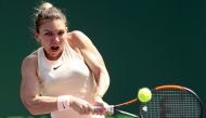  Simona Halep of Romania returns a shot to Agnieszka Radwanska of Poland during the Miami Open Presented by Itau at Crandon Park Tennis Center on March 24, 2018 in Key Biscayne, Florida. Matthew Stockman/Getty Images/AFP