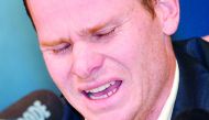 Cricketer Steve Smith reacts at a press conference at the airport in Sydney on March 29, 2018, after returning from South Africa.  AFP / Peter Parks
