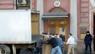 Employees of the US Consulate and removal men load in a truck belongings and objects of the US Consulate in Saint Petersburg on March 31, 2018.  AFP / Olga Maltseva