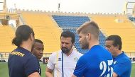 Al Gharafa’s coach Bulent Uygun speaks to his players and coaching staff during a training session on the eve of their AFC Champions League clash against UAE’s Al Jazira yesterday.
