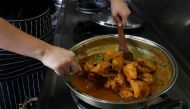 A chef cooks a pot of chicken rendang at a restaurant in Cyberjaya, Selangor, Malaysia April 4, 2018. Reuters