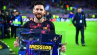 Barcelona's Argentinian forward Lionel Messi holds a framed poster celebrating his 100th Champions League goal ahead of the UEFA Champions League quarter-final first leg football match between Barcelona and AS Roma at the Camp Nou Stadium in Barcelona on 
