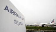 (FILE PHOTO) Sign of Air France at the entrance of the company headquarters, in Roissy-en-France, during a demonstration of Air France workers, ahead an announcement of a restructuring plan by the company. AFP / KENZO TRIBOUILLARD