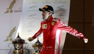 Ferrari's Sebastian Vettel celebrates with the trophy after winning the race REUTERS/Ahmed Jadallah

