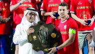 Al Duhail skipper Youssef Msakni receiving the Falcon Shield from Qatar Football Association Vice-President Saoud Al Mohannadi on Saturday. Pictures: Baher Amin / The Peninsula