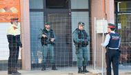 Spanish Guardia Civil guards and Catalan regional policemen Mossos d'Esquadra stand guard at the entrance of a building in Viladecans, near Barcelona, on April 10, 2018 where a member of the Republic Defence Committees (CDR), radical separatist groups, wa