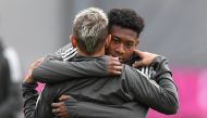 Bayern Munich's Brazilian defender Rafinha (L) and Bayern Munich's Austrian defender David Alaba joke during a training session at the trainings ground of FC Bayern Munich in Munich, southern Germany, on April 10, 2018 on the eve of the UEFA Champions Lea
