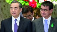 Wang Yi, China's foreign minister, and Taro Kono, Japan's foreign minister, pose during a photo session ahead of a high-level Japan-China economic dialogue in Tokyo, Japan, April 16, 2018. Tomohiro Ohsumi/Pool via Reuters