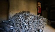 A Syrian man walks past abandoned shells in Douma on the outskirts of Damascus on April 16, 2018 during an organised media tour after the Syrian army declared that all anti-regime forces have left Eastern Ghouta, following a blistering two month offensive