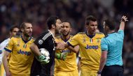 Juventus' Italian goalkeeper Gianluigi Buffon (2L) argues with the referee during the UEFA Champions League quarter-final second leg football match between Real Madrid CF and Juventus FC at the Santiago Bernabeu stadium in Madrid on April 11, 2018. / AFP 