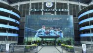 A new poster showing members of the Manchester City team celebrating has been placed at the entrance to the Etihad Stadium in Manchester, north west England to celebrate Manchester City winning the Premier League title on April 16, 2018.  AFP / Paul Ellis